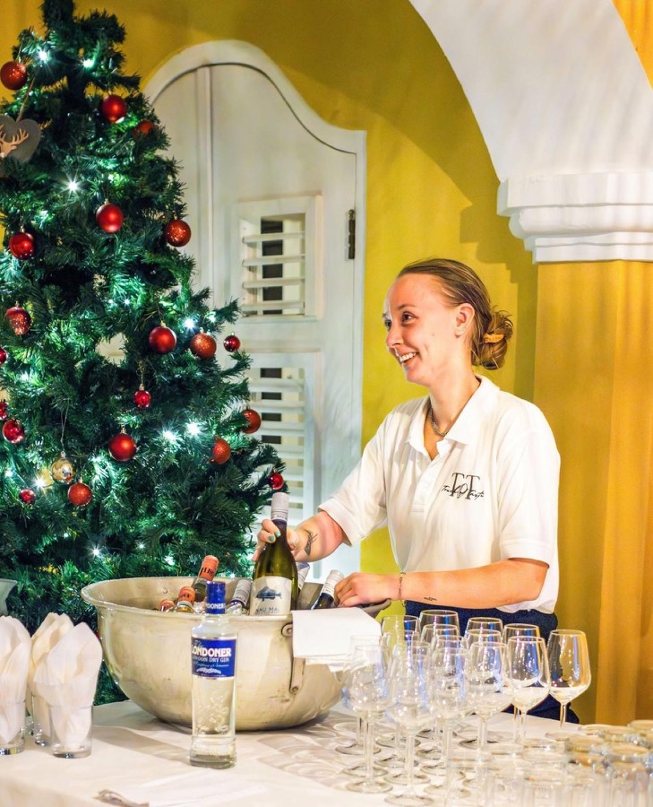 Jeandine serving drinks at a festive event