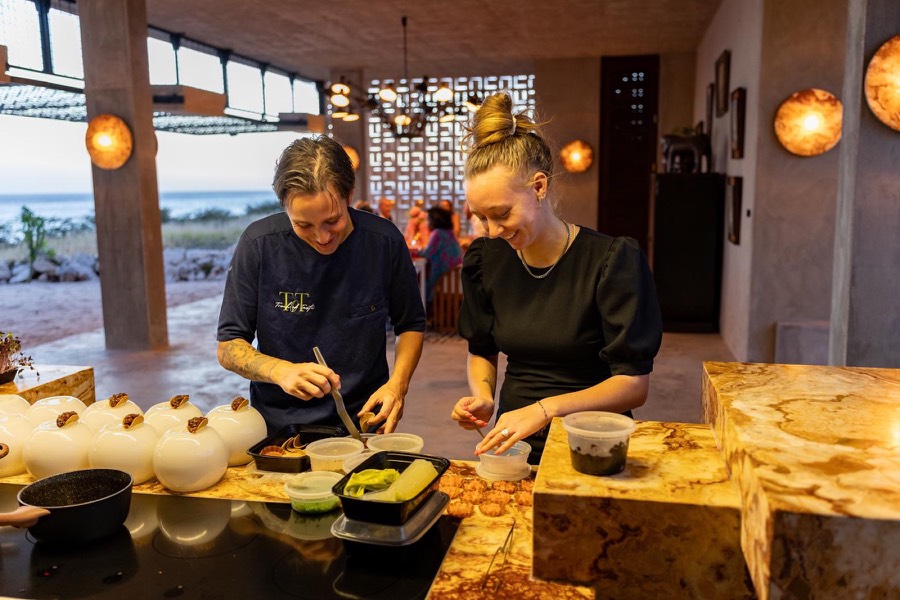 Chefs preparing canapés in an open villa kitchen