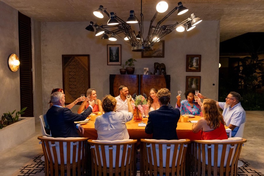 Guests raising a toast at a private dinner in a villa