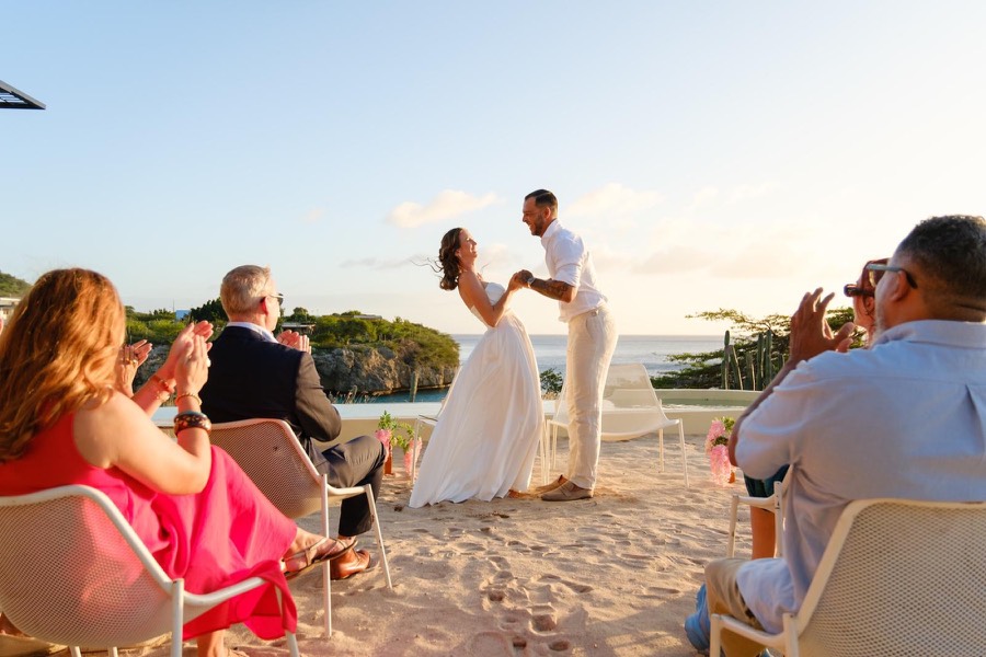 Newlyweds dancing on the beach at sunset in Curaçao